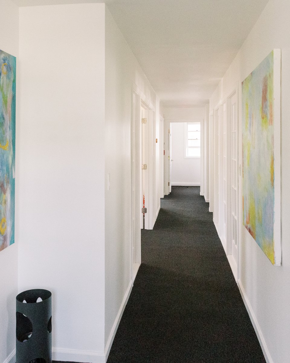 Upstairs hallway at Cherry Street hung with original abstract paintings