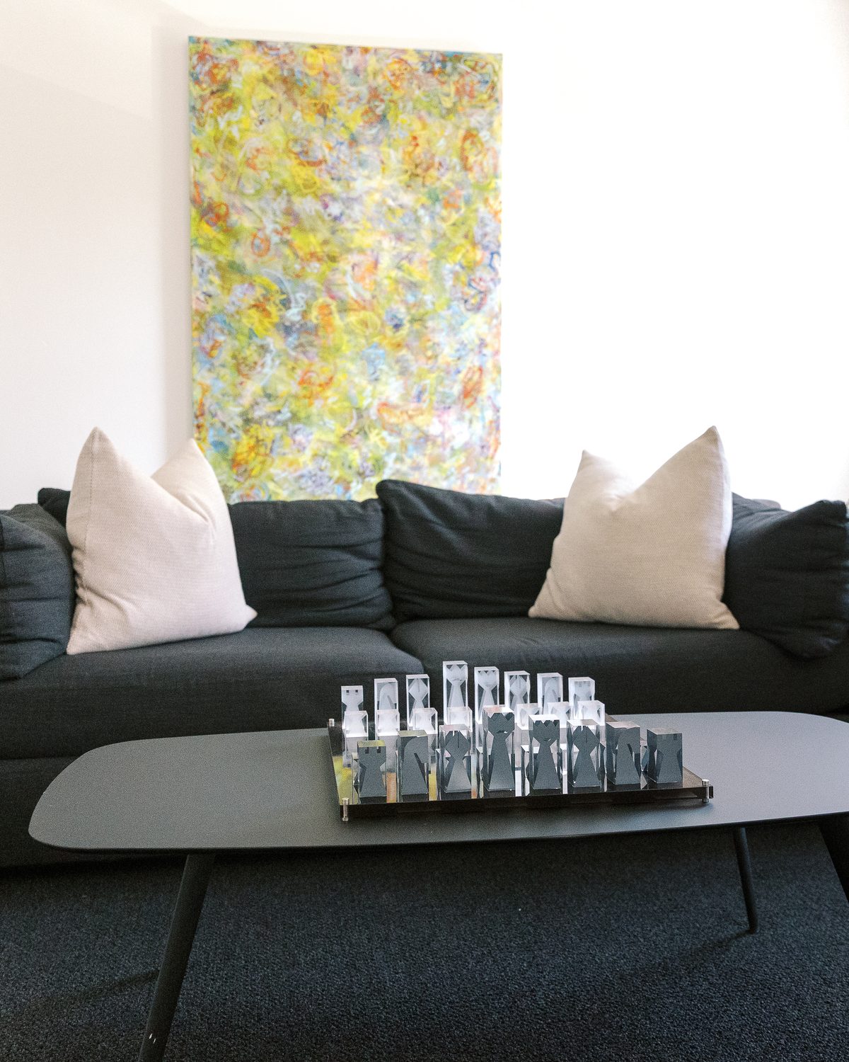 Consult room with white Eames chairs and colorful abstract art
