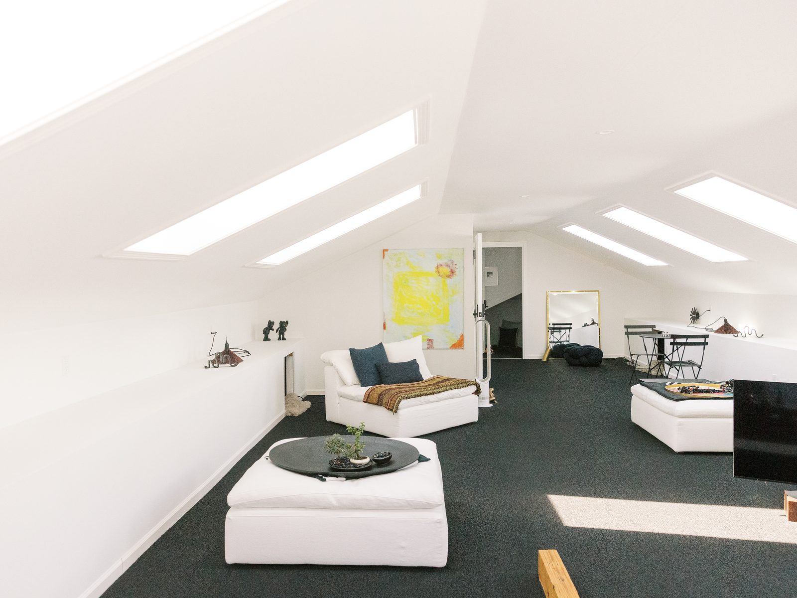 Consult room at CMHS with white Eames chairs and colorful abstract art