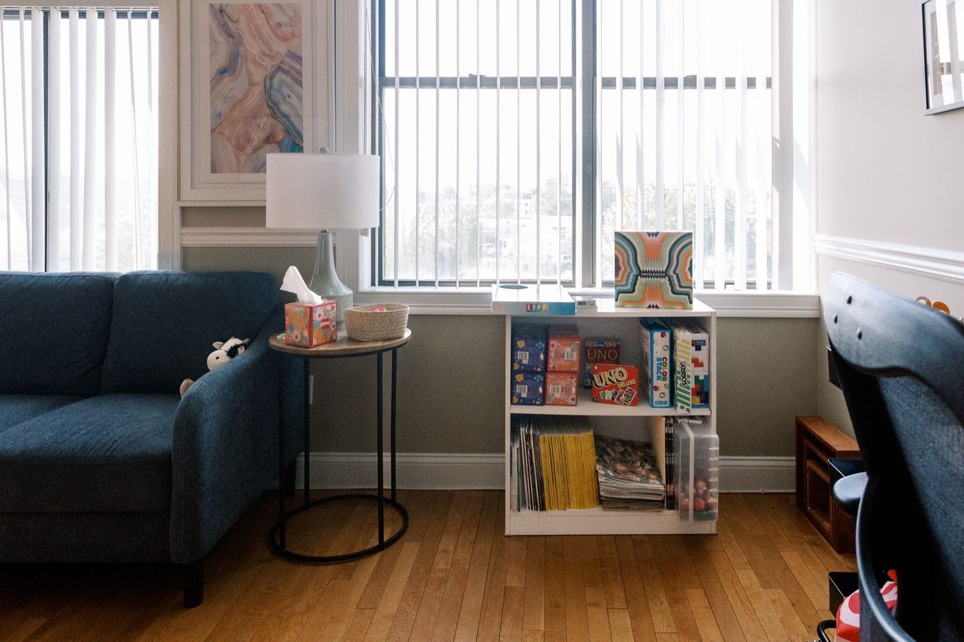 A bright, welcoming CMHS room in Milford for teens and adults, with a blue couch and comfortable seating